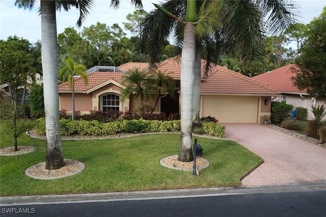 mediterranean / spanish-style house with a garage and a front lawn