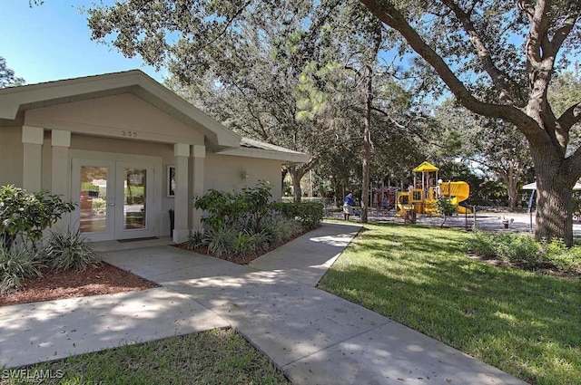 surrounding community featuring a yard and a playground