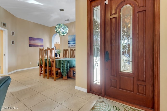 entrance foyer featuring an inviting chandelier and light tile patterned floors