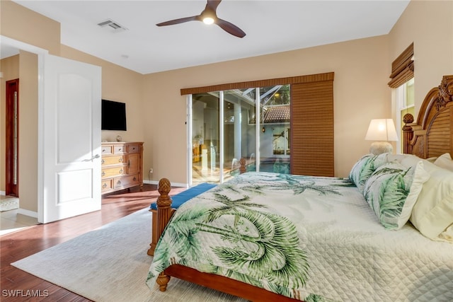 bedroom with hardwood / wood-style flooring, ceiling fan, and access to exterior