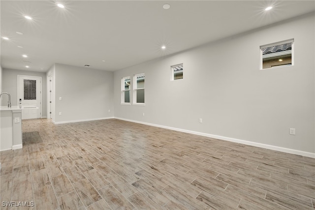 unfurnished living room with light hardwood / wood-style flooring