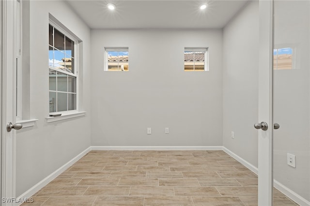 spare room with light hardwood / wood-style flooring and plenty of natural light