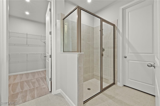 bathroom with tile patterned floors and a shower with shower door