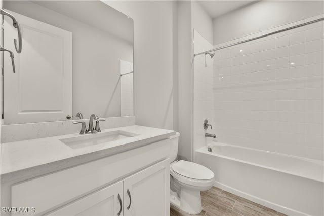 full bathroom with hardwood / wood-style floors, vanity, toilet, and tub / shower combination