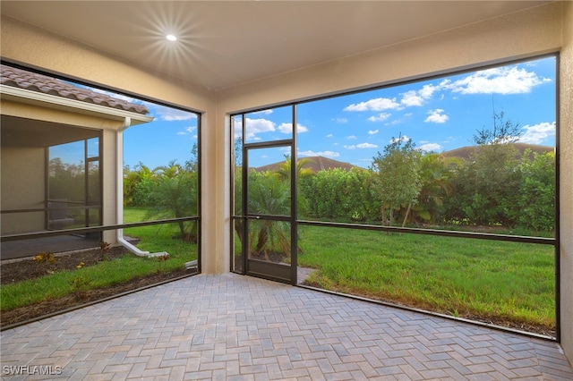 unfurnished sunroom featuring a mountain view