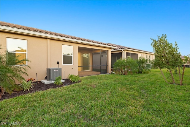 back of house featuring a yard, cooling unit, and a sunroom