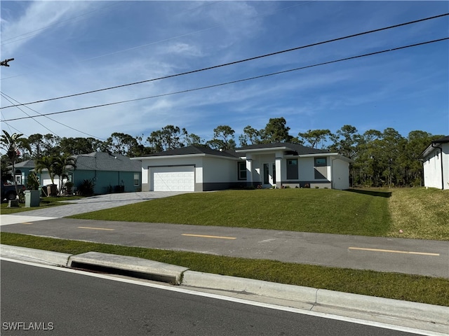 view of front of house with a garage and a front lawn