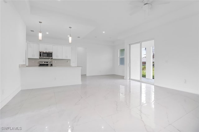 unfurnished living room featuring ceiling fan