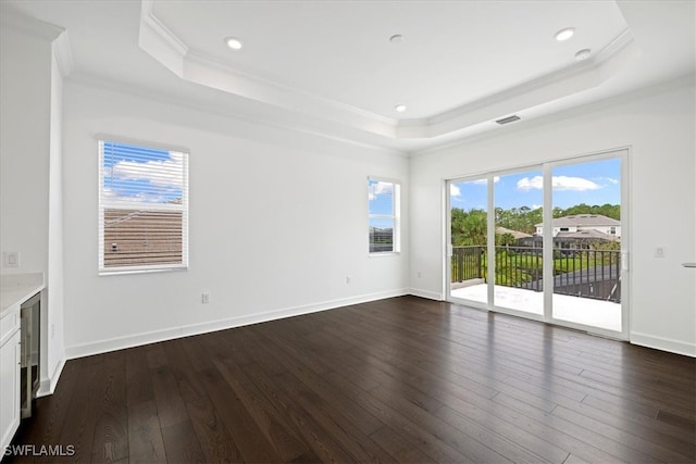 unfurnished living room featuring a raised ceiling, wine cooler, dark hardwood / wood-style flooring, and ornamental molding