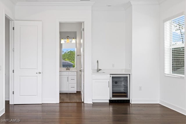 bar featuring dark hardwood / wood-style flooring, white cabinetry, crown molding, and wine cooler