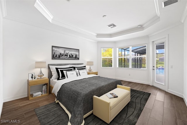 bedroom featuring access to exterior, wood-type flooring, multiple windows, and crown molding