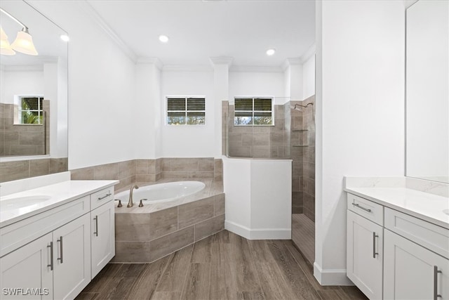 bathroom featuring vanity, separate shower and tub, wood-type flooring, and crown molding