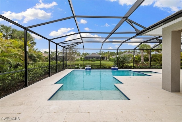 view of pool featuring glass enclosure and a patio area