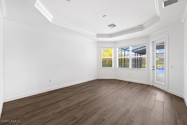 spare room featuring crown molding, dark hardwood / wood-style flooring, and a healthy amount of sunlight