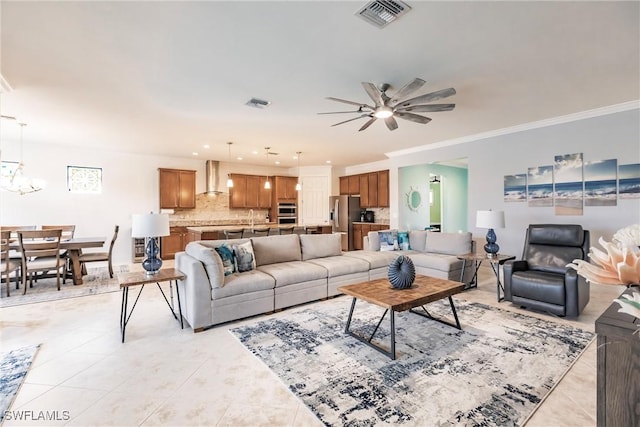 living room featuring light tile patterned flooring, ceiling fan with notable chandelier, and ornamental molding