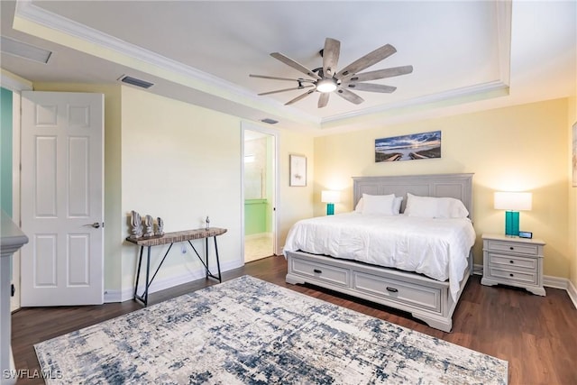 bedroom with ensuite bath, ceiling fan, dark wood-type flooring, and crown molding