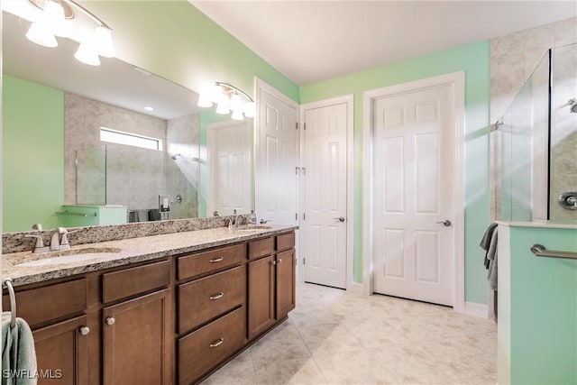 bathroom featuring tile patterned flooring, vanity, and an enclosed shower