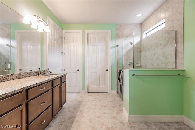 bathroom featuring vanity, tile patterned floors, and walk in shower