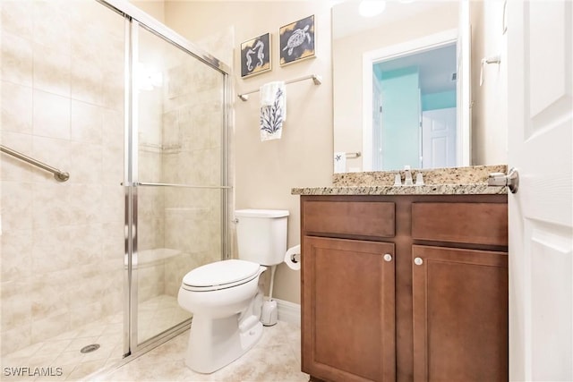 bathroom with tile patterned flooring, vanity, toilet, and walk in shower