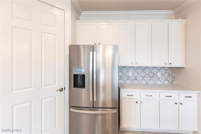 11041 Castlereagh St, Fort Myers, FL 33913 - kitchen featuring decorative backsplash, light countertops, white cabinets, stainless steel fridge, and ornamental molding