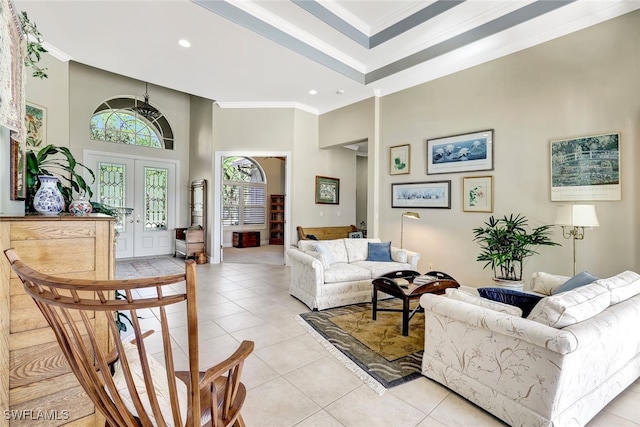 tiled living room featuring crown molding, french doors, and a high ceiling