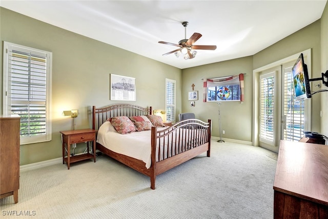 carpeted bedroom featuring french doors, access to outside, and ceiling fan