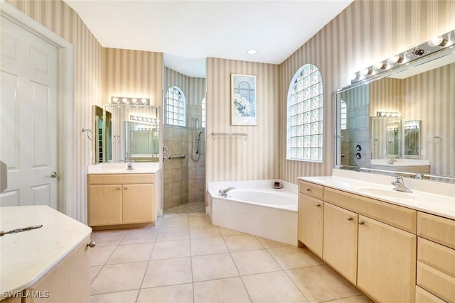 bathroom with tile patterned flooring, vanity, and independent shower and bath