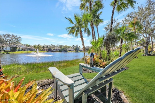 exterior space with a water view and a yard