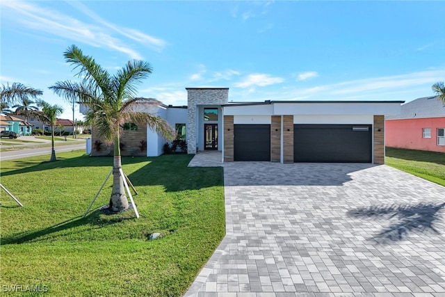 view of front of home featuring a garage and a front lawn