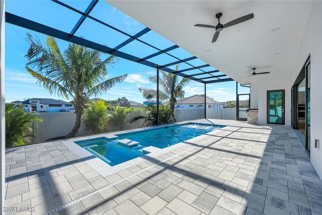 view of pool featuring a lanai, a patio area, ceiling fan, and an in ground hot tub