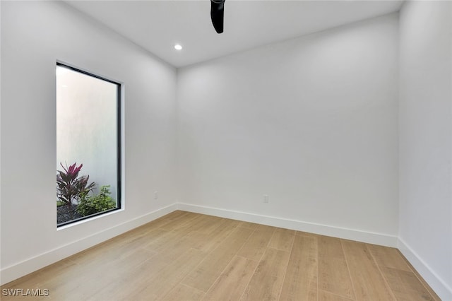 spare room featuring ceiling fan and light hardwood / wood-style floors