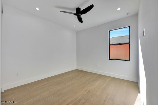 spare room featuring ceiling fan and light hardwood / wood-style flooring