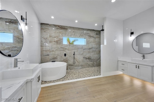 bathroom featuring vanity, shower with separate bathtub, and tile walls