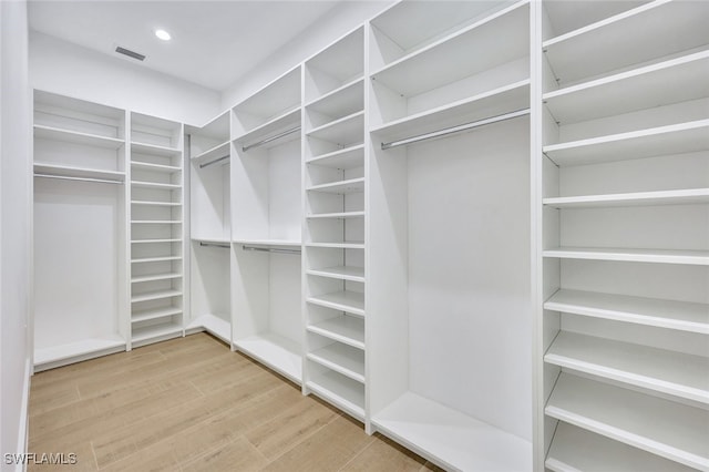 walk in closet featuring hardwood / wood-style flooring