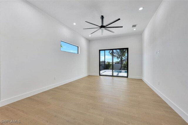 empty room featuring ceiling fan and light hardwood / wood-style floors