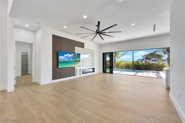 unfurnished living room with ceiling fan and light hardwood / wood-style floors