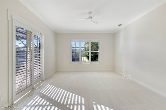 empty room featuring light carpet, ceiling fan, and ornamental molding