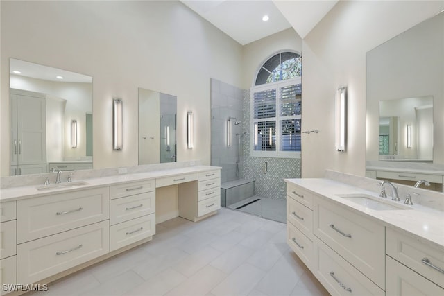 bathroom with tile patterned flooring, vanity, lofted ceiling, and walk in shower