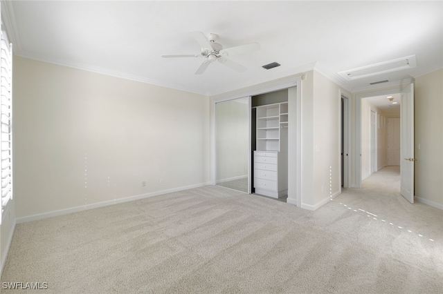 unfurnished bedroom with ceiling fan, ornamental molding, light carpet, and a closet