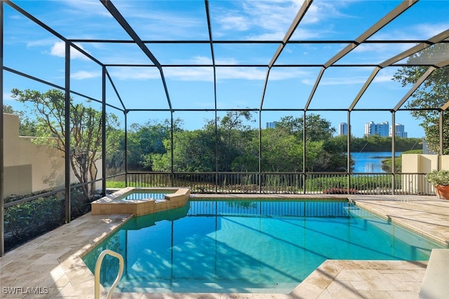 view of swimming pool featuring an in ground hot tub, a patio, a water view, and a lanai