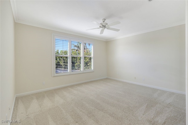 carpeted spare room featuring ceiling fan and ornamental molding