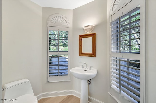 7817 Vizcaya Way, Naples, FL 34108 - bathroom featuring baseboards, toilet, and wood finished floors