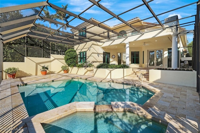 view of swimming pool with french doors, glass enclosure, ceiling fan, and a patio area