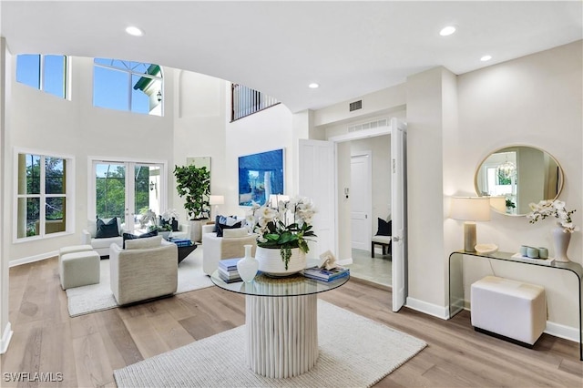 7817 Vizcaya Way, Naples, FL 34108 - living room with light wood finished floors, baseboards, a high ceiling, and recessed lighting