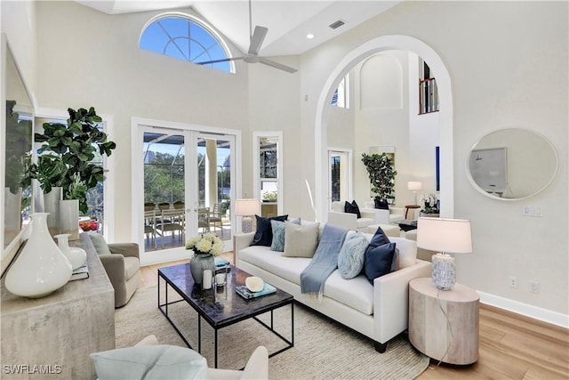 7817 Vizcaya Way, Naples, FL 34108 - living area featuring a ceiling fan, light wood-type flooring, french doors, a high ceiling, and baseboards