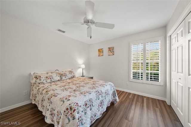 bedroom featuring ceiling fan, dark hardwood / wood-style flooring, and a closet