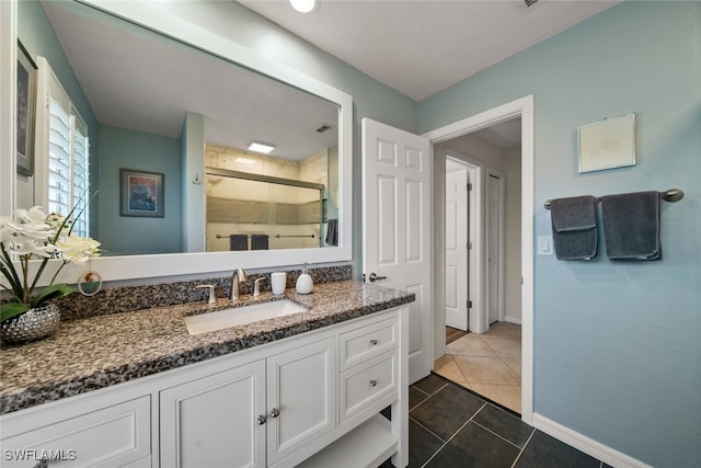 bathroom featuring tile patterned flooring, vanity, and a shower with door