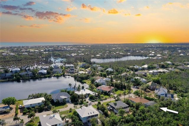 aerial view at dusk with a water view