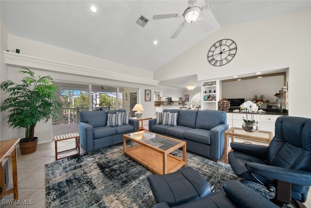 tiled living room featuring ceiling fan and lofted ceiling