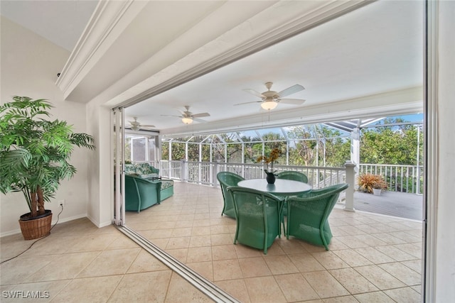 sunroom / solarium featuring ceiling fan